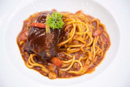 spaghetti bolognese sauce with pork ribs roast on white plate, Traditional italian spaghettiの写真素材