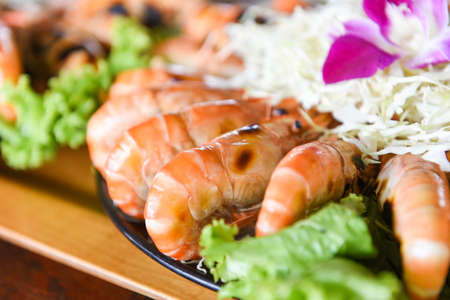 Grilled shrimp prawn with fresh vegetable and seafood sauce,  shrimps grilled serve on tray - seafood buffet Thai foodの写真素材