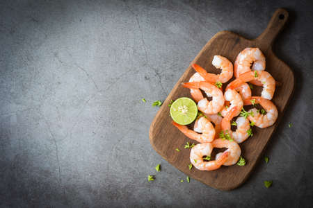 Fresh shrimps prawns seafood lemon lime with herbs and spiceの写真素材