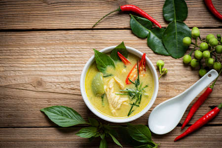 Chicken green curry Thai food on soup bowl with ingredient vegetable herbs and spices pepper chili...