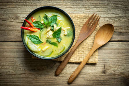 Traditional green curry chicken cuisine asian food, Chicken green curry Thai food on soup bowl with ingredient vegetable herbs and spices pepper chili. Top viewの写真素材