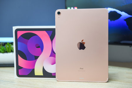 Bangkok, Thailand - August 21, 2021: New Apple iPad rose gold color, camera and rear view logo Apple launch Tablet iPad Air 2020-2021 (4th Gen.) with box on the tableのeditorial素材