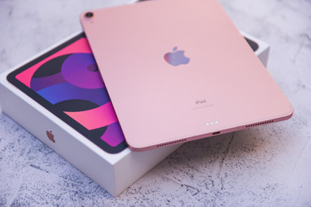 Bangkok, Thailand - August 21, 2021: New Apple iPad rose gold color, camera and rear view logo Apple launch Tablet iPad Air 2020-2021 (4th Gen.) with box on the tableのeditorial素材