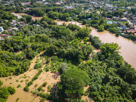 Aerial view river flood village countryside Asia and forest tree, Top view river with water flood...