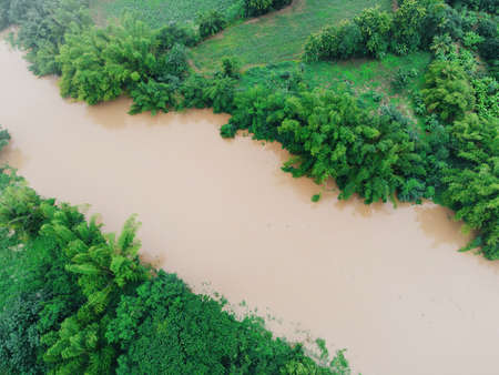 Aerial view river flood forest nature woodland area green tree, Top view river lagoon pond with water flood from above, Bird eye view landscape jungles lake flowing wild water after the rainの写真素材