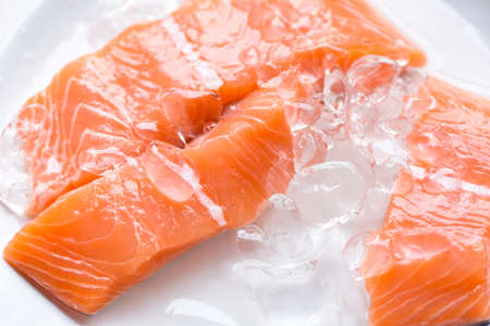 Fresh salmon fish on ice, Close up raw salmon filet seafood for sashimiの写真素材