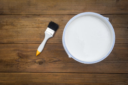Painted tool with paint brush paint bucket canned paint for painting on wooden background, top viewの写真素材