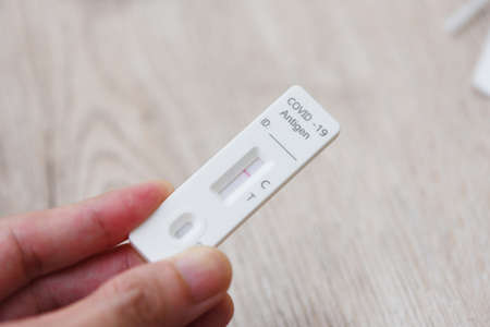 Covid-19 antigen test kit in hand, Tested for Covid-19 with a nasal swab. Rapid Antigen Test during...