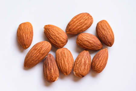 Almonds on white background top view on the table, Close up roasted almond nuts natural protein food and for snackの写真素材