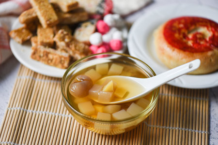Chinese desserts chinese pastry bean cake, Snack mix nuts candies sweets sugar nuts sesame seeds coated beans puffed rice, milk pudding fruit salad longan juice bowl in chinese new year festival foodの写真素材