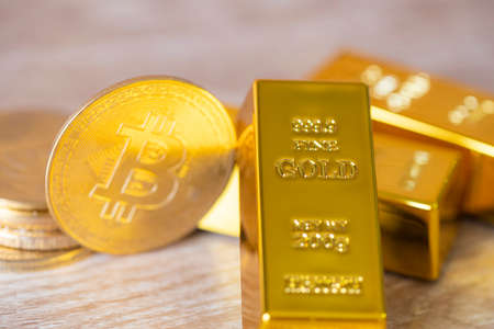 Bitcoin and Gold trading, gold bars on table background, pile of gold bars financial business...