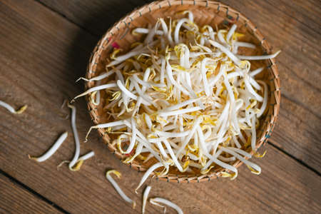 Bean sprouts on wooden basket table background in the kitchen, Raw white organic bean sprouts or mung bean sprout for food veganの写真素材