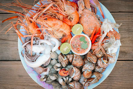 seafood plate with shrimp shellfish crab squid cockle spotted babylon with seafood sauce chili lemon...