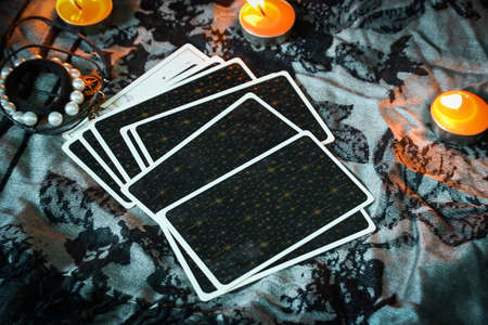 Tarot reading with tarot card background and candlelight on the table for Astrology Occult Magic...