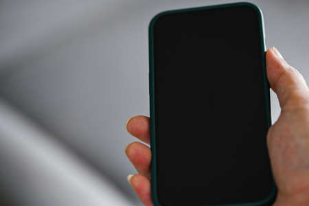 hand holding phone online technology concept , business man hand holding smart phone blank black...