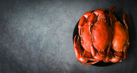 fresh crab on black plate background, seafood crab cooking food boiled or steamed crab red in the seafood restaurant - top viewの写真素材