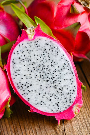 dragon fruit cut half on wooden with pitahaya background , fresh dragon fruit tropical in the asian thailand healthy fruit conceptの写真素材