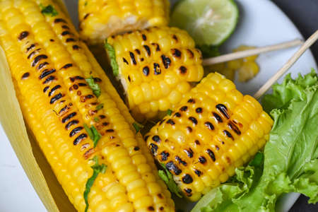 sweet corn food with lime and coriander, ripe corn cobs grilled sweetcorn for food vegan dinner or...