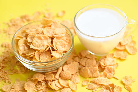Cornflakes with milk on yellow background, cornflakes bowl breakfast food and snack for healthy food...