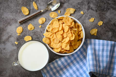 Cornflakes with milk on dark background, cornflakes bowl breakfast food and snack for healthy food...
