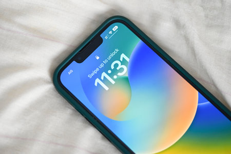 iPhone with iOS 16 logo on home screen, close up new operating system 2022-2023 on iPhone apple devices version ios 16 screen display iPhone : Bangkok, Thailand - September 2022のeditorial素材