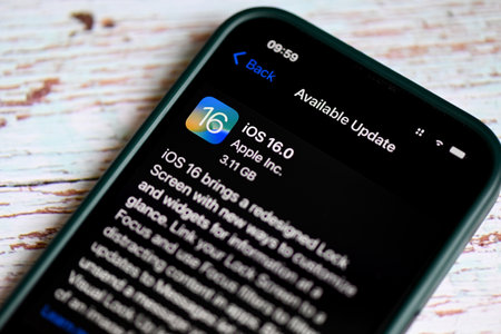 iPhone with iOS 16 logo on the screen close up, new operating system 2022-2023 on iPhone apple...