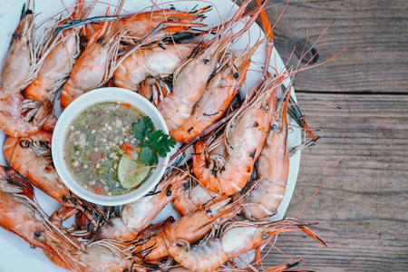 Grilled Shrimp - Shrimp burn bbq seafood on plate shrimps prawns cooking burnt on grill barbecue cooked and seafood sauce - top viewの写真素材