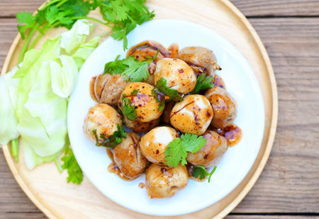 Meatballs on plate with with spicy sauce, Grilled meatball and pork ball, Meat ball on skewers and fresh coriander vegetables, Thai food Asian food Meat balls, pork balls - top viewの写真素材