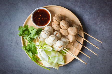 Meatballs on plate with with spicy sauce, Grilled meatball and pork ball, Meat ball on skewers and fresh coriander vegetables cabbage, Thai food Asian food Meat balls - pork ballsの写真素材