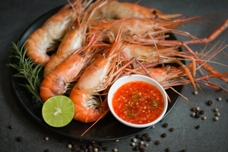 shrimp grilled delicious seasoning spices on black background appetizing cooked shrimps baked prawns...