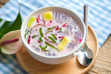Thai rice flour dessert, Thai dessert -cantaloupe jelly mixed fruit with coconut milk and syrup sweets dessert on bowl, Asian foodの写真素材