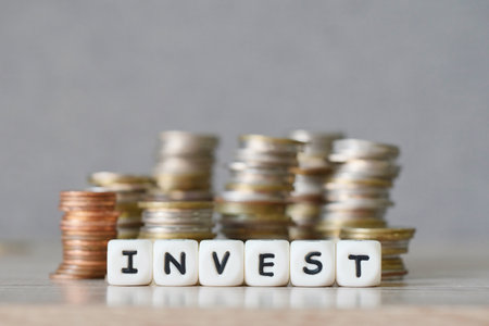 invest and a coin on wooden table background, invest business economy concept of money and finance investmentsの写真素材
