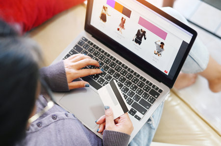 woman shopping online , women relaxing at home online shopping website on laptop easy e-commerce online shop pay with credit card asian female happiness shopping in home on holidayの写真素材