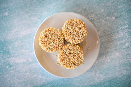 instant noodles on white plate, raw instant noodles circle for cooking food - top viewの写真素材
