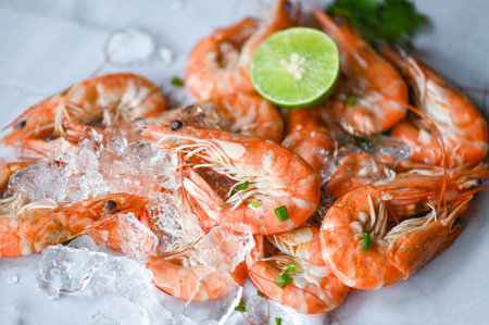 shrimp on seafood plate and wooden background dining table food, Fresh shrimps prawns  lemon lime with herbs and spiceの写真素材