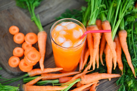 fresh and sweet carrot slices for cooking food fruits and vegetables for health concept, fresh carrots juice on glass with ice on summer, carrot juice on wooden table backgroundの写真素材