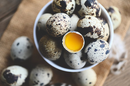 quail eggs on bowl, fresh quail eggs on wooden table background, raw eggs with peel egg shellの写真素材