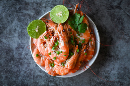 shrimp on white bolw and wooden background dining table food, Fresh shrimps prawns seafood lemon lime with herbs and spice, top viewの写真素材