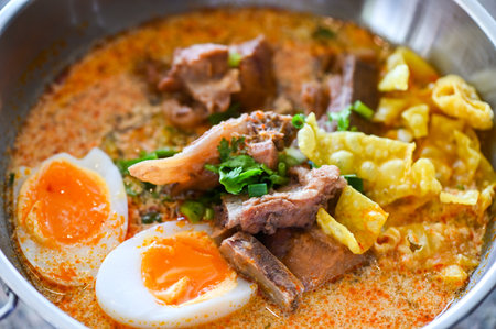 curry bone soup - bone soup pork with boiled eggs in hot pot, Thai food tom yum hot and sour soupの写真素材
