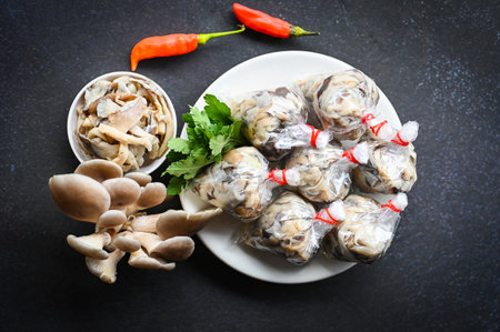 Fresh grey oyster mushroom on plate, cooked oyster mushroom for cooking food - processed food street mushroom packageの写真素材