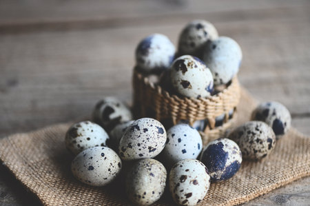 quail eggs on basket, fresh quail eggs on wooden table background, raw eggs with peel egg shellの写真素材