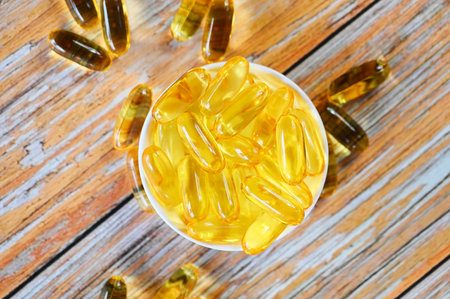 Fish oil capsules with omega 3 and vitamin D Cod liver oil omega 3 gel capsules, healthy diet conceptの写真素材