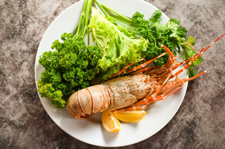 spiny lobster food on plate, fresh lobster or rock lobster seafood with herb and spices lemon coriander parsley lettuce salad, lobster for cooking food - top viewの写真素材
