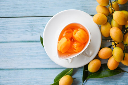 Sweet dessert marian plum fruit  on bowl for food and wooden background, tropical fruit Name in Thailand sweet Yellow Marian Plum Maprang Plango or Mayong chidの写真素材