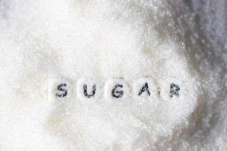 heap of sugar on background, white sugar for food and sweets dessert candy heap of sweet sugar crystalline granulated - top viewの写真素材