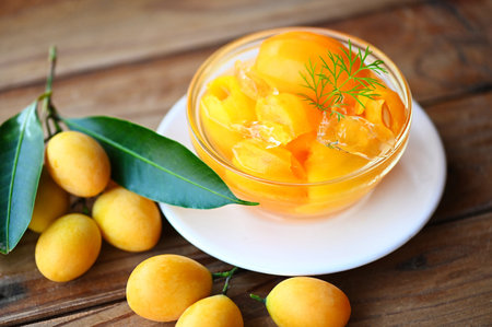 Sweet dessert marian plum fruit  on bowl for food and wooden background, tropical fruit Name in Thailand sweet Yellow Marian Plum Maprang Plango or Mayong chidの写真素材