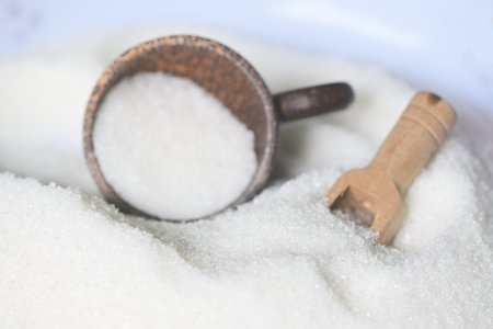 Sugar background, on wooden scoop , white sugar for food and sweets dessert candy heap of sweet sugar crystalline granulatedの写真素材
