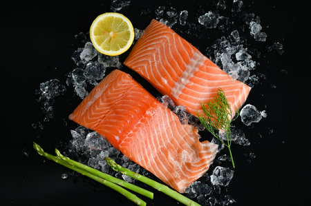 salmon fillet with lemon asparagus herb and spices, fresh raw salmon fish on ice for cooking food seafood salmon fish - top viewの写真素材