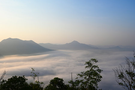 sunrise mist cover mountain background winter foggy view at beautiful misty spring mountain valley and mountains in mist on background, landscape forest in the morning beautifulの写真素材