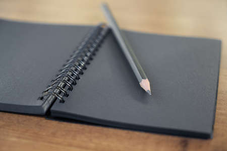 Pen and notepad on the tableの写真素材